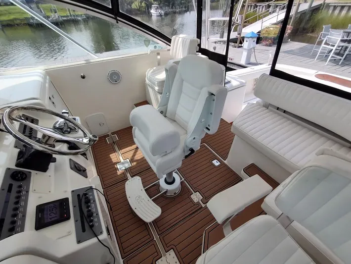 Reel Time Yacht Photos Pics 2005 Rampage 38 Express boat interior with white seating and wooden flooring.