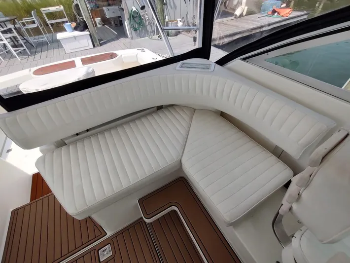 Reel Time Yacht Photos Pics Luxurious seating area on a 2005 Rampage 38 Express boat, featuring white cushioned seats.