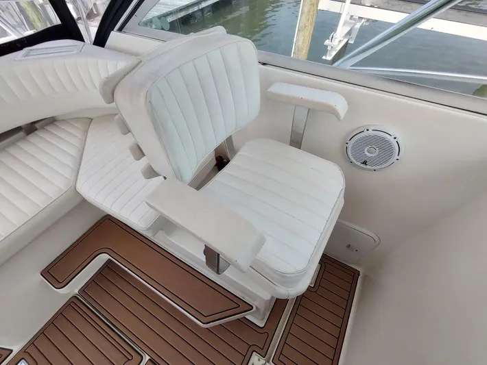 Reel Time Yacht Photos Pics White seating area on 2005 Rampage 38 Express boat with wood-patterned flooring.