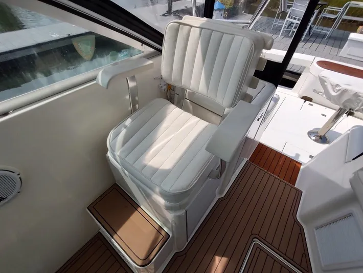 Reel Time Yacht Photos Pics Captain's chair on 2005 Rampage 38 Express boat with teak flooring.