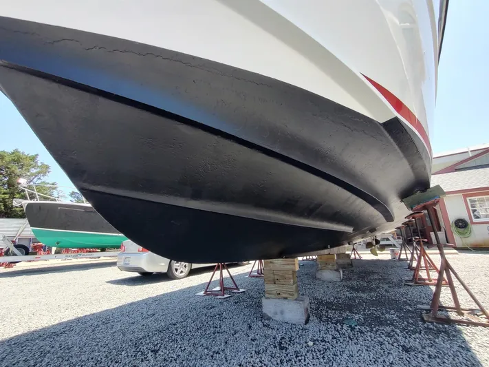 Reel Time Yacht Photos Pics 2005 Rampage 38 Express boat on stands, showcasing its black hull and sleek design.