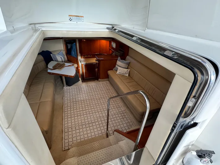 Fathom This Yacht Photos Pics Interior of 2001 Sea Ray 420 Aft Cabin yacht, featuring cozy seating and elegant wood finishes.