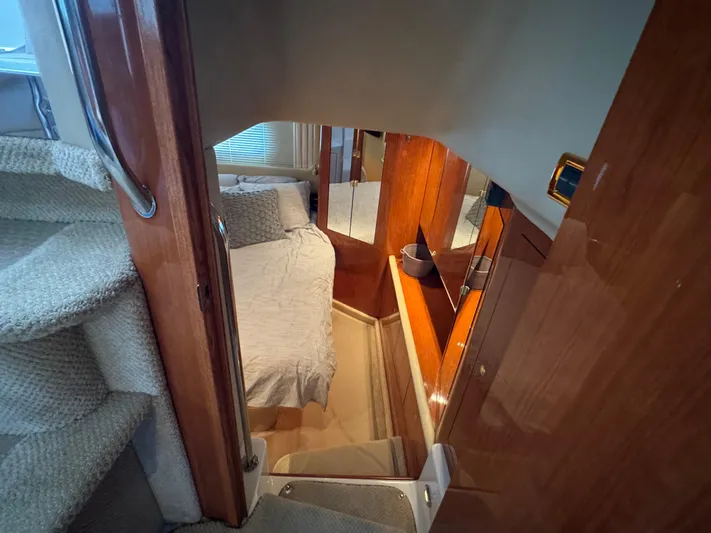 Fathom This Yacht Photos Pics Interior of 2001 Sea Ray 420 Aft Cabin with cozy bedroom and wooden finishes.