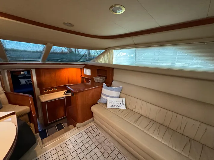 Fathom This Yacht Photos Pics Luxurious interior of 2001 Sea Ray 420 Aft Cabin yacht with cozy seating and elegant wood finishes.