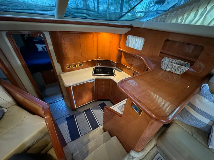 Fathom This Yacht Photos Pics 2001 Sea Ray 420 Aft Cabin interior with wood cabinetry and compact kitchen area.