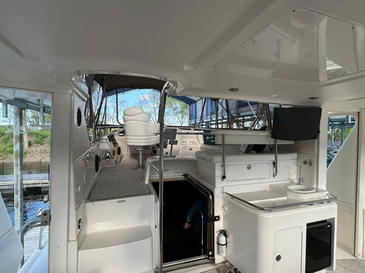 Fathom This Yacht Photos Pics 2001 Sea Ray 420 Aft Cabin interior with helm, seating, and kitchenette.