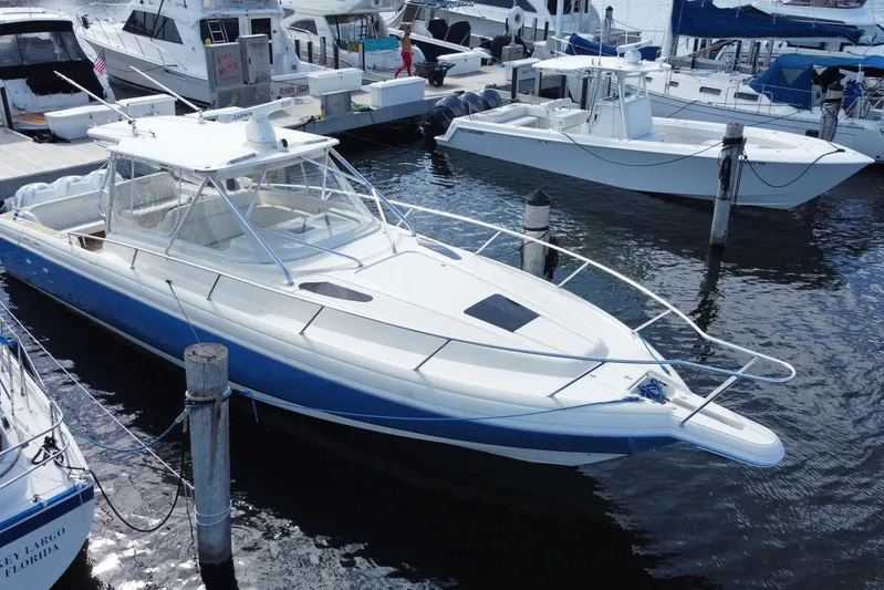  Yacht Photos Pics 2006 Intrepid 377 boat docked in marina, surrounded by other vessels.