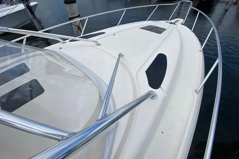  Yacht Photos Pics 2006 Intrepid 377 boat deck with stainless steel railings, docked at marina.