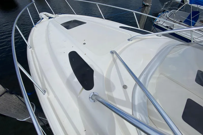  Yacht Photos Pics 2006 Intrepid 377 boat deck with stainless steel railings, docked at marina.