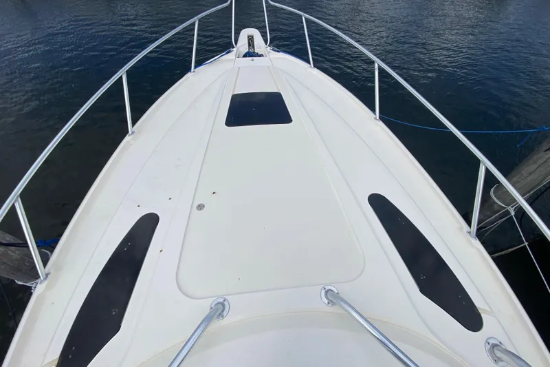  Yacht Photos Pics Bow view of a 2006 Intrepid 377 boat docked on calm water.