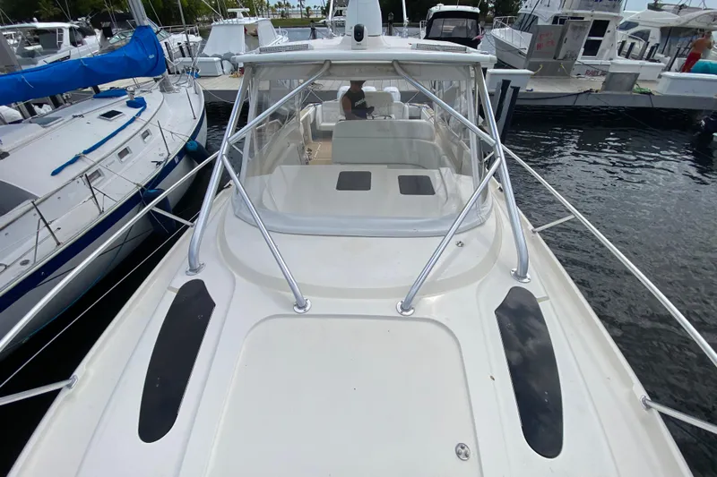  Yacht Photos Pics 2006 Intrepid 377 boat docked, featuring sleek design and spacious deck area.