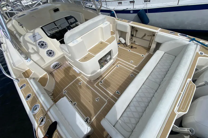  Yacht Photos Pics 2006 Intrepid 377 boat interior with beige seating and modern dashboard.