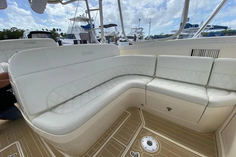  Yacht Photos Pics Luxurious white seating on a 2006 Intrepid 377 boat, docked with other vessels.