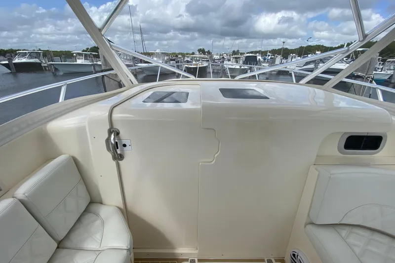  Yacht Photos Pics 2006 Intrepid 377 boat interior with seating, docked at marina under cloudy sky.