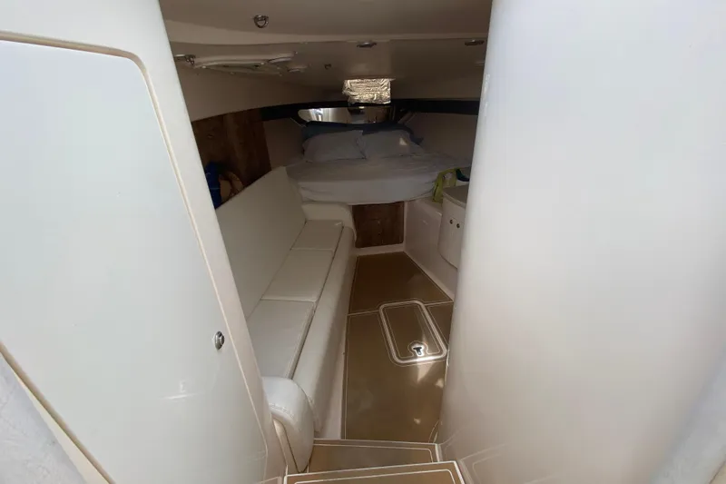  Yacht Photos Pics Interior cabin of a 2006 Intrepid 377 boat with bed and seating area.