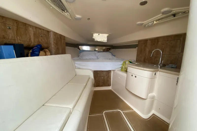  Yacht Photos Pics Interior of a 2006 Intrepid 377 boat with bed, seating, and kitchenette.