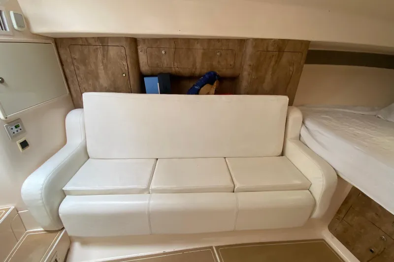  Yacht Photos Pics Interior of a 2006 Intrepid 377 boat with white seating and wooden accents.