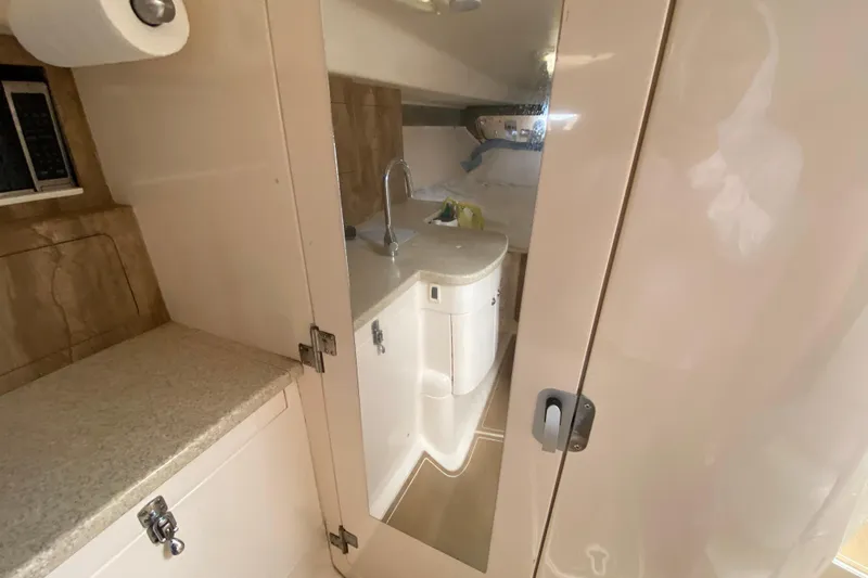  Yacht Photos Pics 2006 Intrepid 377 boat interior with compact bathroom and sink.