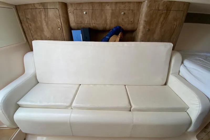  Yacht Photos Pics White leather sofa in 2006 Intrepid 377 boat interior with wooden cabinets.