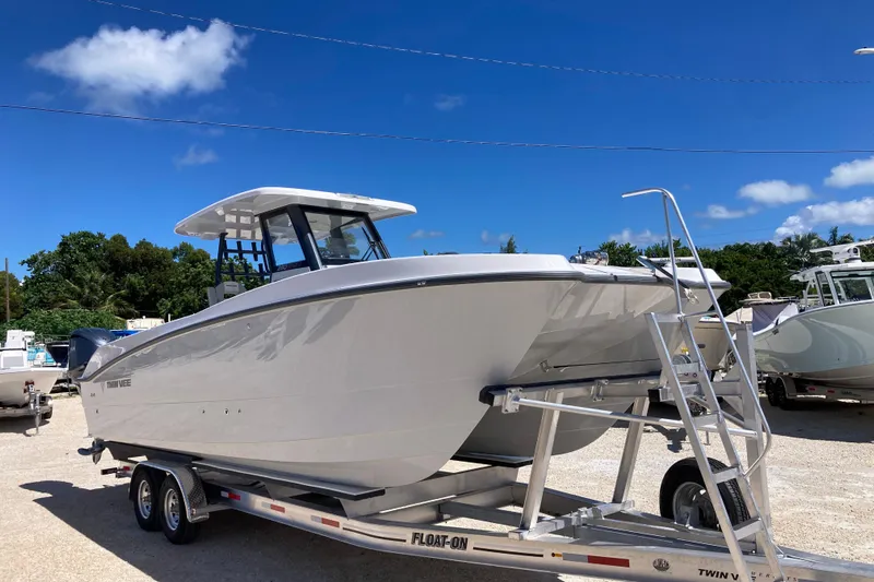 The Grey Ghost Yacht Photos Pics 2026 Twin Vee 280 GFX CC boat on trailer under clear blue sky.