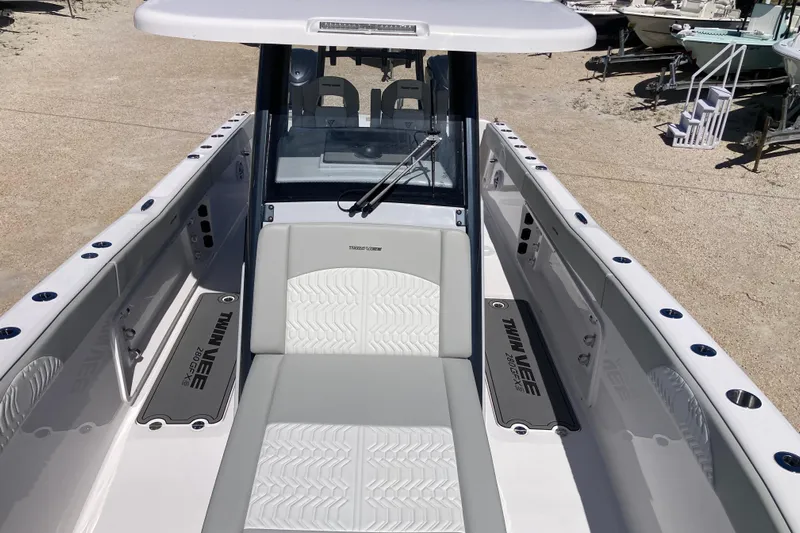 The Grey Ghost Yacht Photos Pics 2026 Twin Vee 280 GFX CC boat interior with seating and console, docked outdoors.