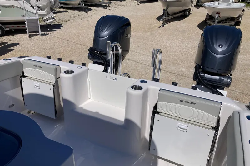 The Grey Ghost Yacht Photos Pics 2026 Twin Vee 280 GFX CC boat with dual Yamaha outboard engines, docked on gravel.