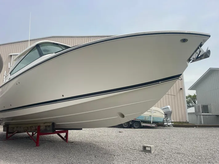  Yacht Photos Pics 2016 Pursuit DC 325 Dual Console boat on gravel lot.