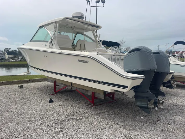  Yacht Photos Pics 2016 Pursuit DC 325 Dual Console boat displayed on gravel.