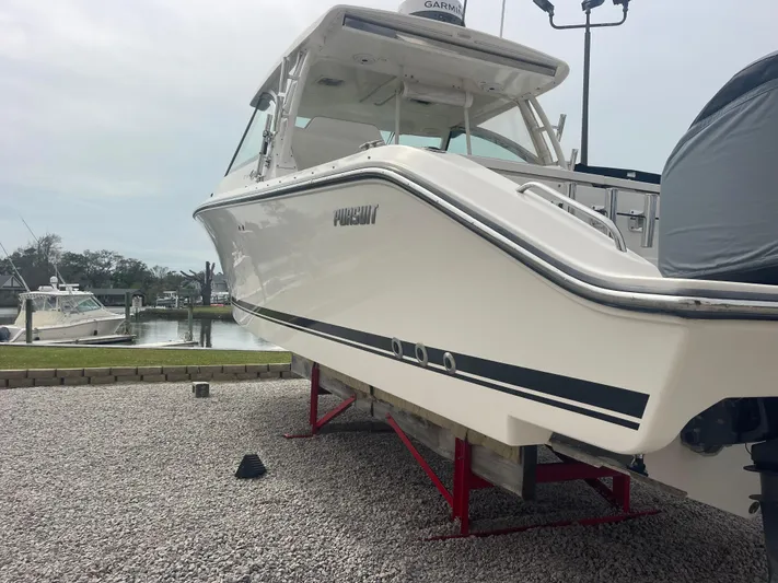  Yacht Photos Pics 2016 Pursuit DC 325 Dual Console boat on gravel lot.