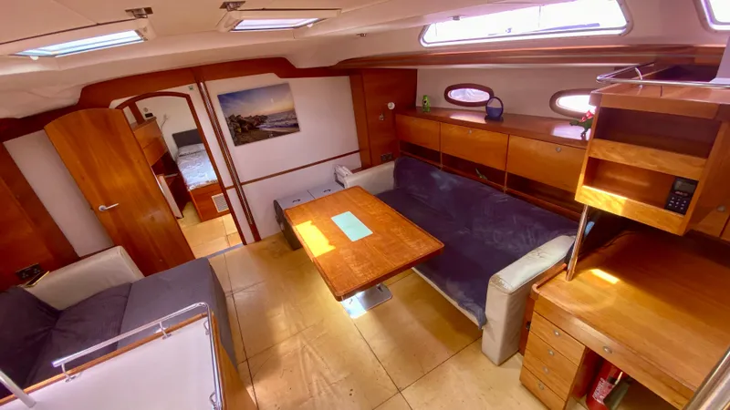  Yacht Photos Pics Spacious interior of 2004 Hanse 531 yacht with wooden furnishings and cozy seating area.