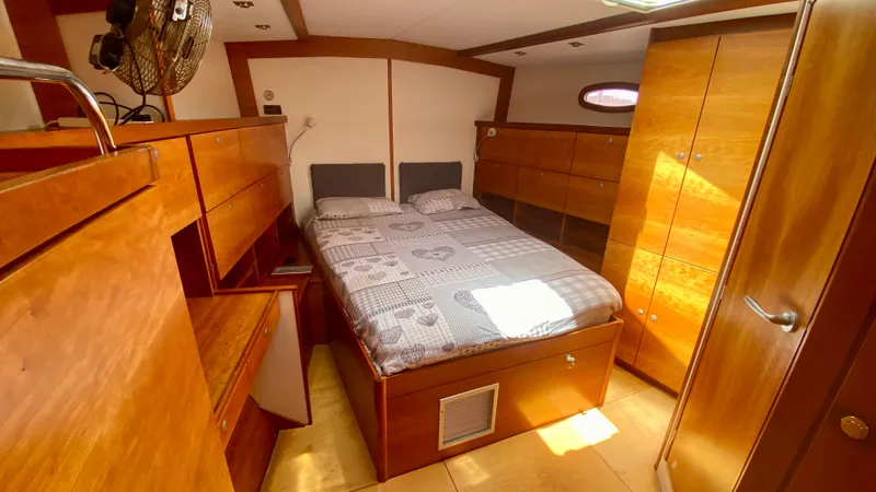  Yacht Photos Pics Luxurious 2004 Hanse 531 yacht cabin with wooden interior and cozy double bed.