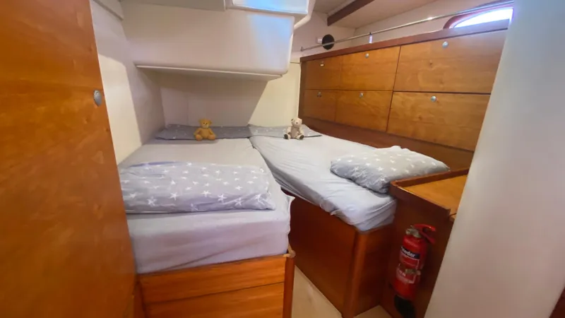  Yacht Photos Pics Cabin interior of 2004 Hanse 531 yacht with twin beds and wooden storage.