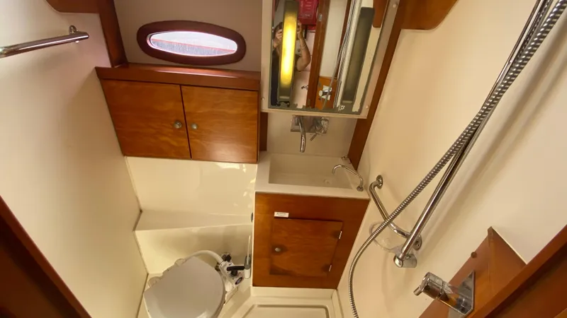  Yacht Photos Pics Bathroom interior of 2004 Hanse 531 yacht with wooden cabinets and shower.