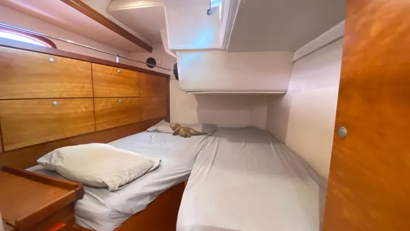  Yacht Photos Pics 2004 Hanse 531 yacht cabin with twin beds and wooden storage cabinets.