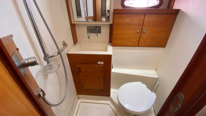  Yacht Photos Pics Compact bathroom in a 2004 Hanse 531 yacht with shower, sink, and toilet.