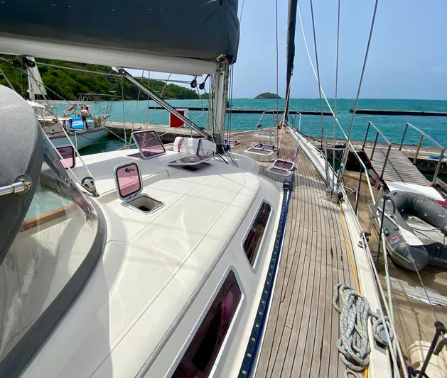  Yacht Photos Pics 2004 Hanse 531 yacht docked, showcasing sleek deck design and vibrant turquoise waters.