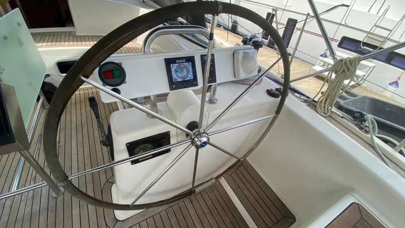  Yacht Photos Pics Steering wheel of 2004 Hanse 531 yacht with navigation instruments on teak deck.