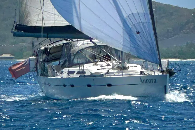  Yacht Photos Pics Sailing yacht Hanse 531, 2004 model, named Aurora, navigating clear blue waters.