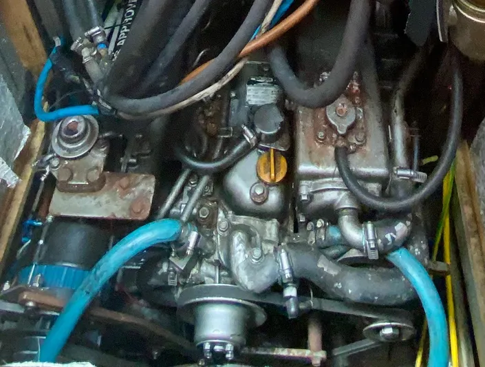  Yacht Photos Pics Engine compartment of a 2004 Hanse 531 sailboat, featuring various hoses and mechanical components.