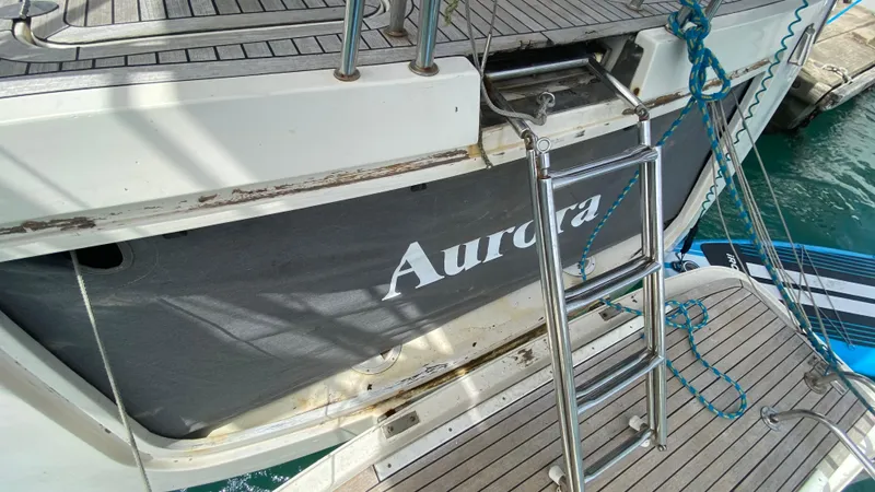  Yacht Photos Pics Hanse 531 yacht from 2004, featuring a boarding ladder and deck, named "Aurora."