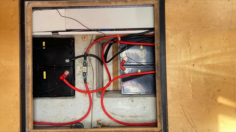  Yacht Photos Pics Battery compartment of a 2004 Hanse 531 yacht with red cables and connectors.