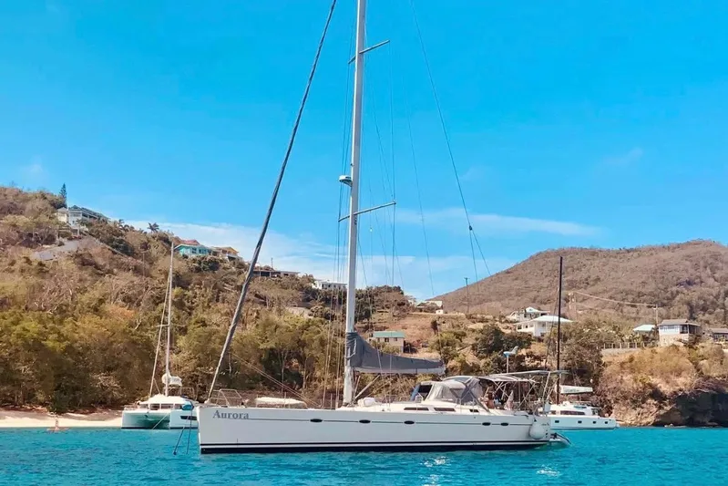  Yacht Photos Pics Sailing yacht Hanse 531, 2004 model, anchored in a scenic coastal bay.