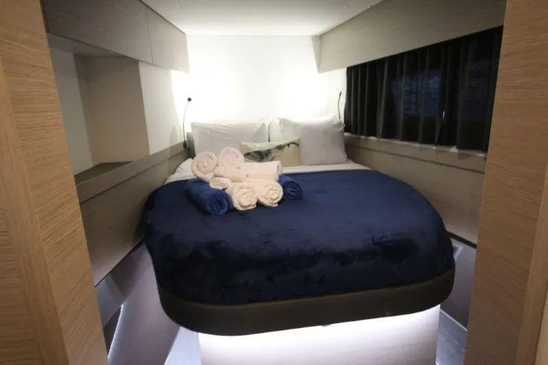 Ruckus Yacht Photos Pics Luxurious bedroom interior of 2021 Fountaine Pajot Catamaran Elba 45 with plush bedding.