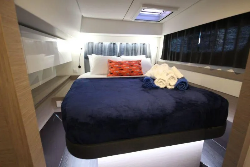 Ruckus Yacht Photos Pics Luxurious cabin interior of 2021 Fountaine Pajot Catamaran Elba 45 with cozy bedding.