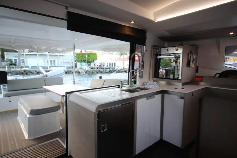 Ruckus Yacht Photos Pics Interior view of 2021 Fountaine Pajot Catamaran Elba 45, featuring modern kitchen and outdoor seating.
