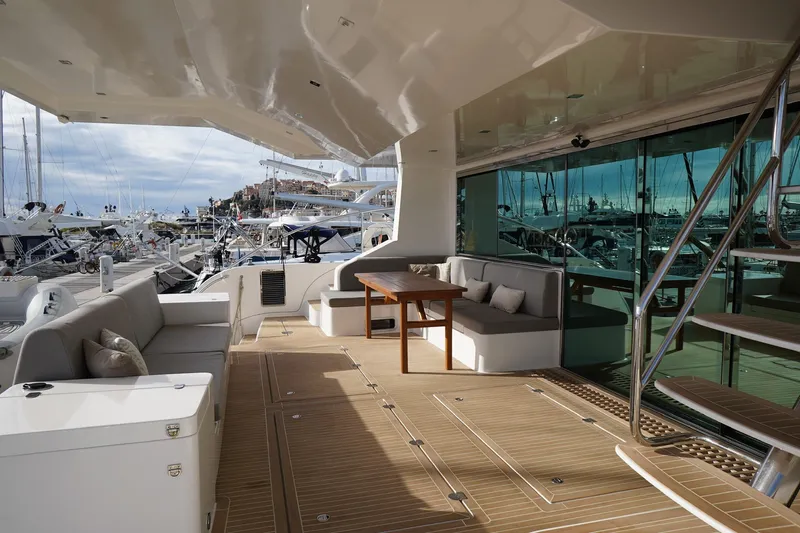 Melissa Yacht Photos Pics Luxurious 2022 Silent 60 yacht deck with elegant seating and marina view.