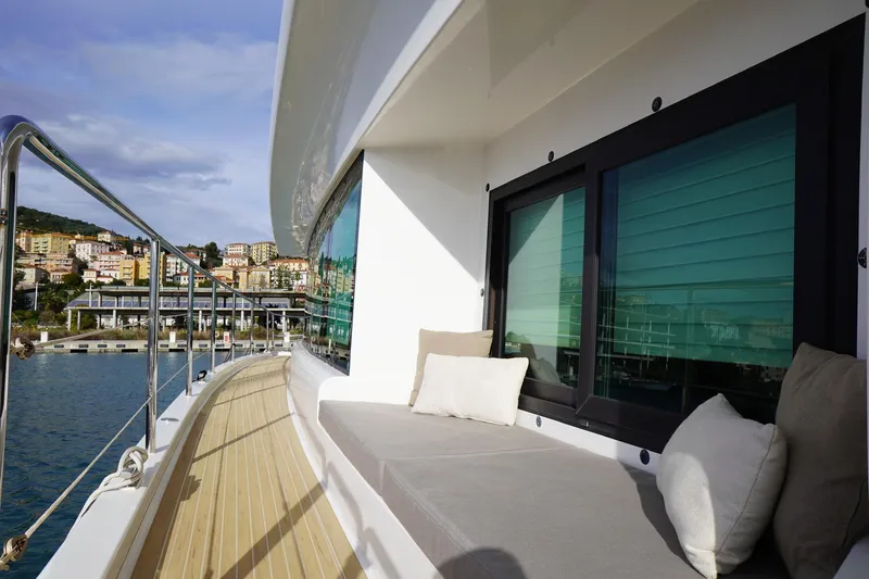 Melissa Yacht Photos Pics Luxurious Silent 60 yacht deck with cushions, overlooking coastal town, 2022 model.