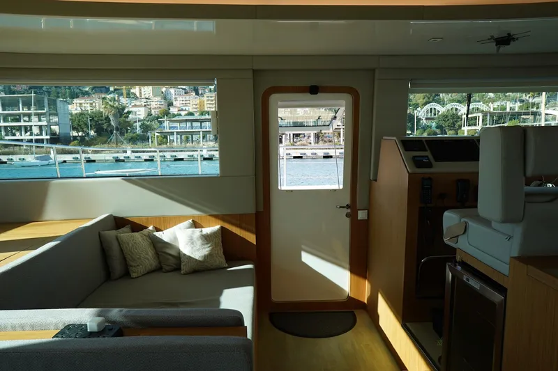 Melissa Yacht Photos Pics Interior of 2022 Silent 60 yacht with modern furnishings and scenic window view.