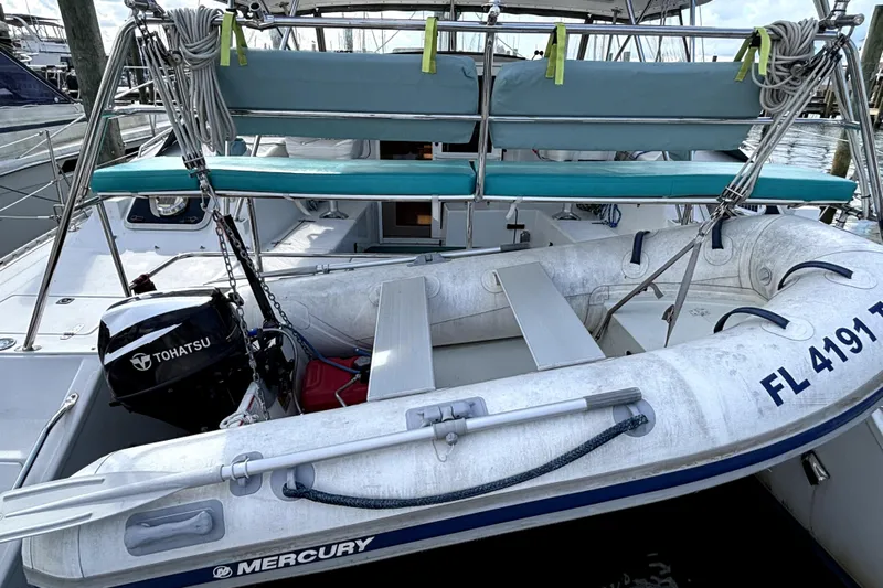 Serenity Yacht Photos Pics 2003 PDQ 36 Capella with inflatable dinghy and Tohatsu outboard motor docked at marina.