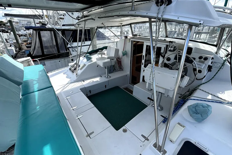 Serenity Yacht Photos Pics 2003 PDQ 36 Capella catamaran cockpit with seating, helm, and marina view.